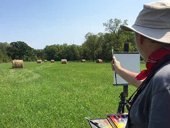 John Hulsey plein air painting in a field